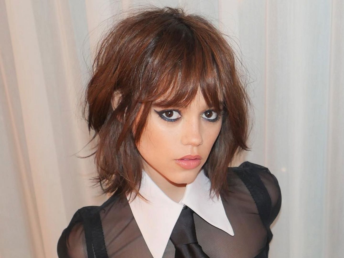 Collarbone-length wolf cut with soft face-framing layers and slightly flipped ends - the most wearable entry point into the style